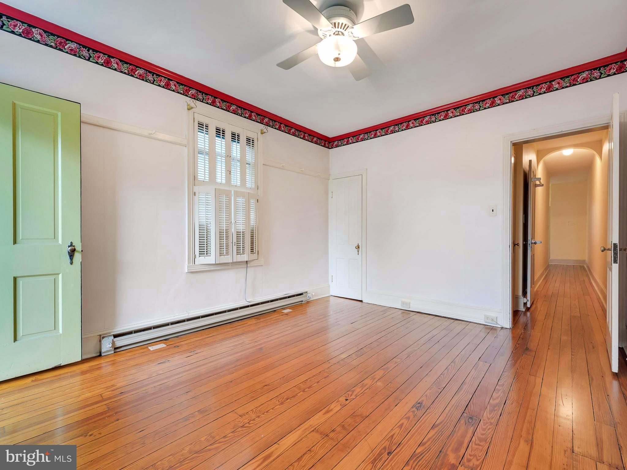 123 East 3rd Street Frederick, MD 21701 - Photo 19 of 28 a view of an empty room with wooden floor and a window