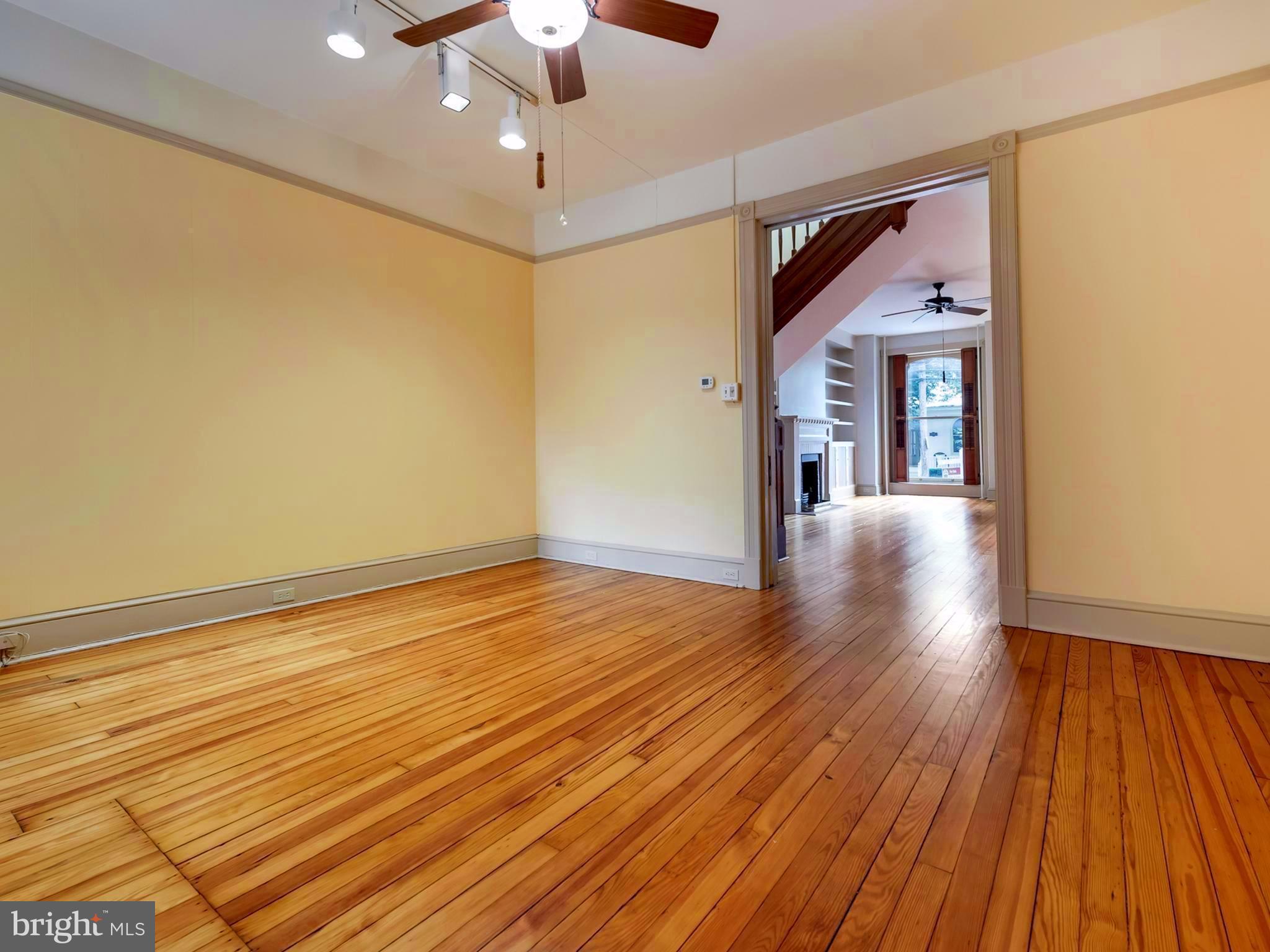 123 East 3rd Street Frederick, MD 21701 - Photo 5 of 28 wooden floor in an empty room with a window