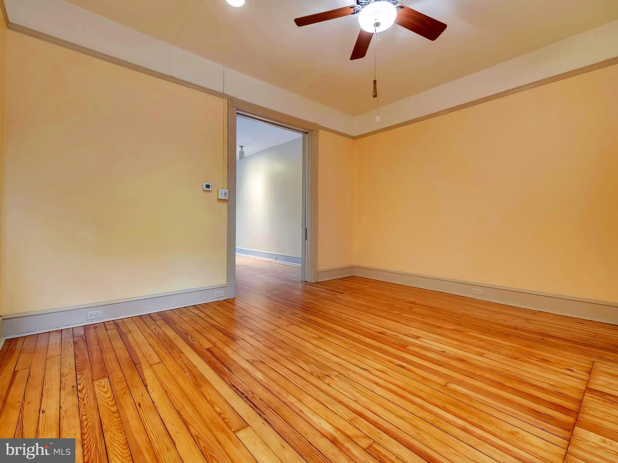 123 East 3rd Street Frederick, MD 21701 - Photo 6 of 28 wooden floor in an empty room with a window