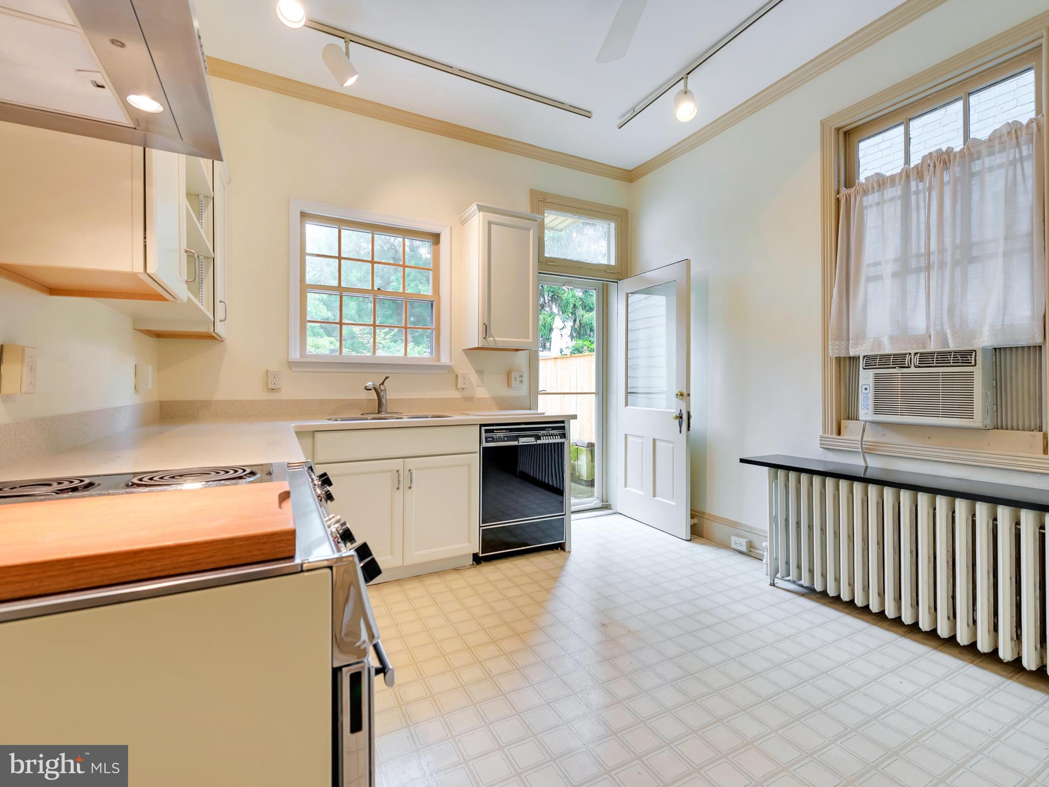 123 East 3rd Street Frederick, MD 21701 - Photo 8 of 28 a kitchen with a stove a sink and a refrigerator