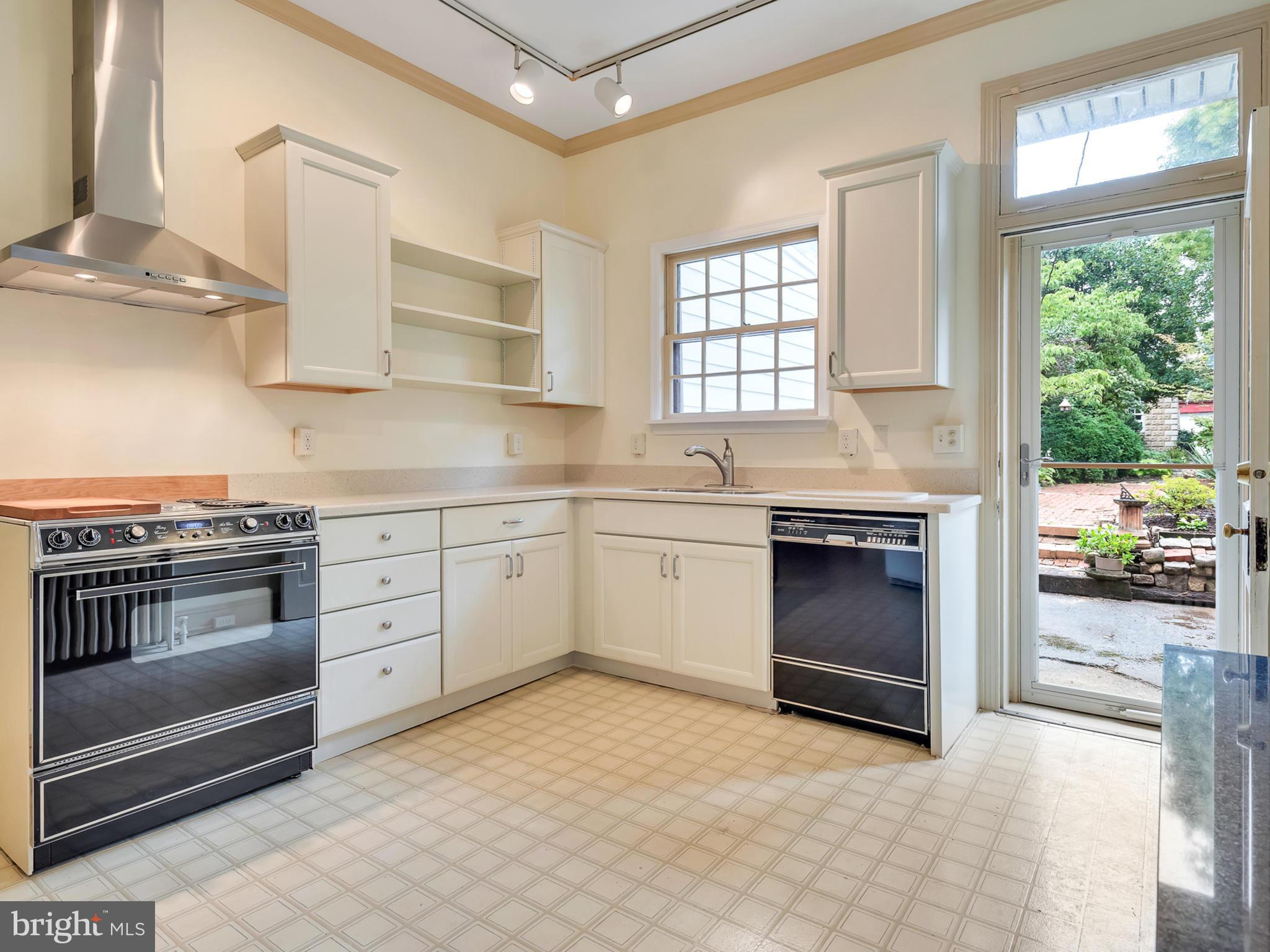 123 East 3rd Street Frederick, MD 21701 - Photo 9 of 28 a kitchen with stainless steel appliances a stove sink and cabinets