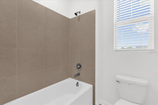 a bathroom with a bathtub and a toilet