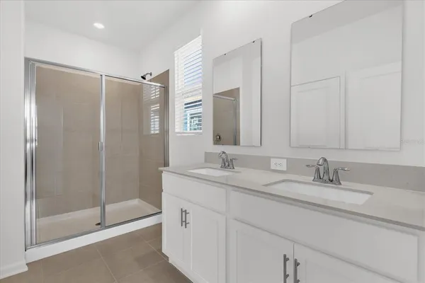 a bathroom with double sink and a mirror