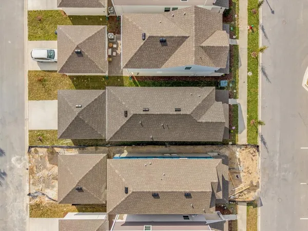 an aerial view of residential houses with outdoor space