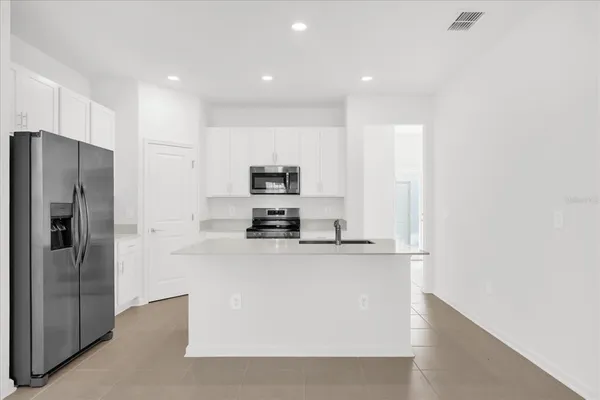 a kitchen with stainless steel appliances a refrigerator and a stove