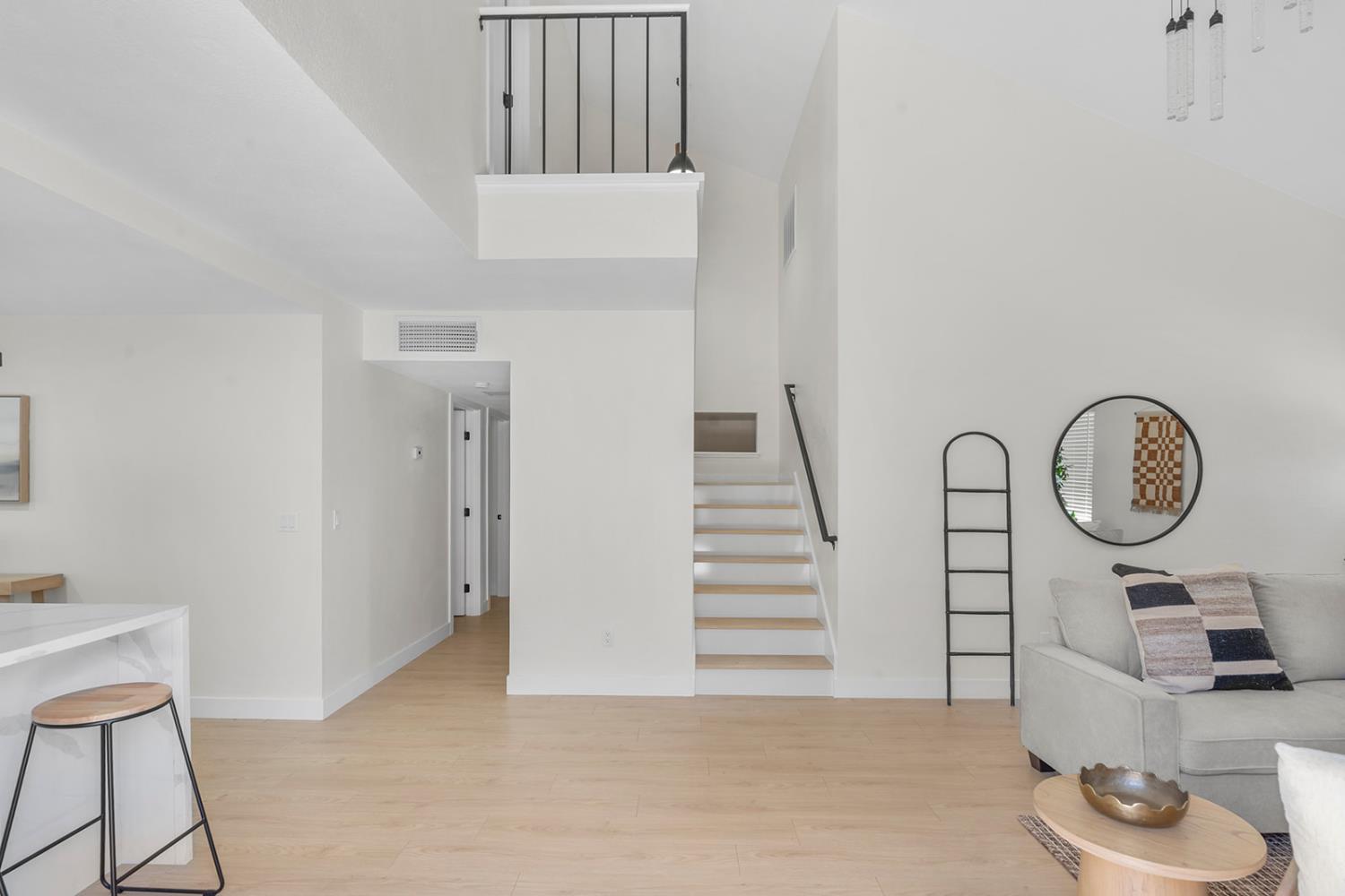 7531 Event Way Sacramento, CA 95842 - Photo 14 of 36 stairs with laminate floors and a towering ceiling