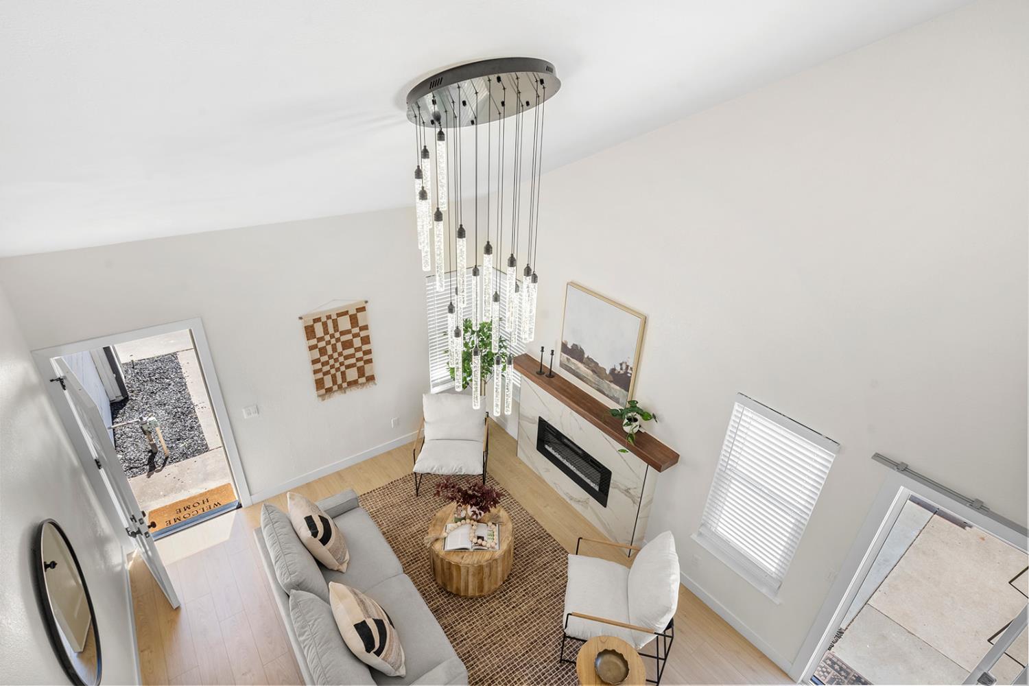 7531 Event Way Sacramento, CA 95842 - Photo 22 of 36 living room with a electric fireplace and a towering ceiling
