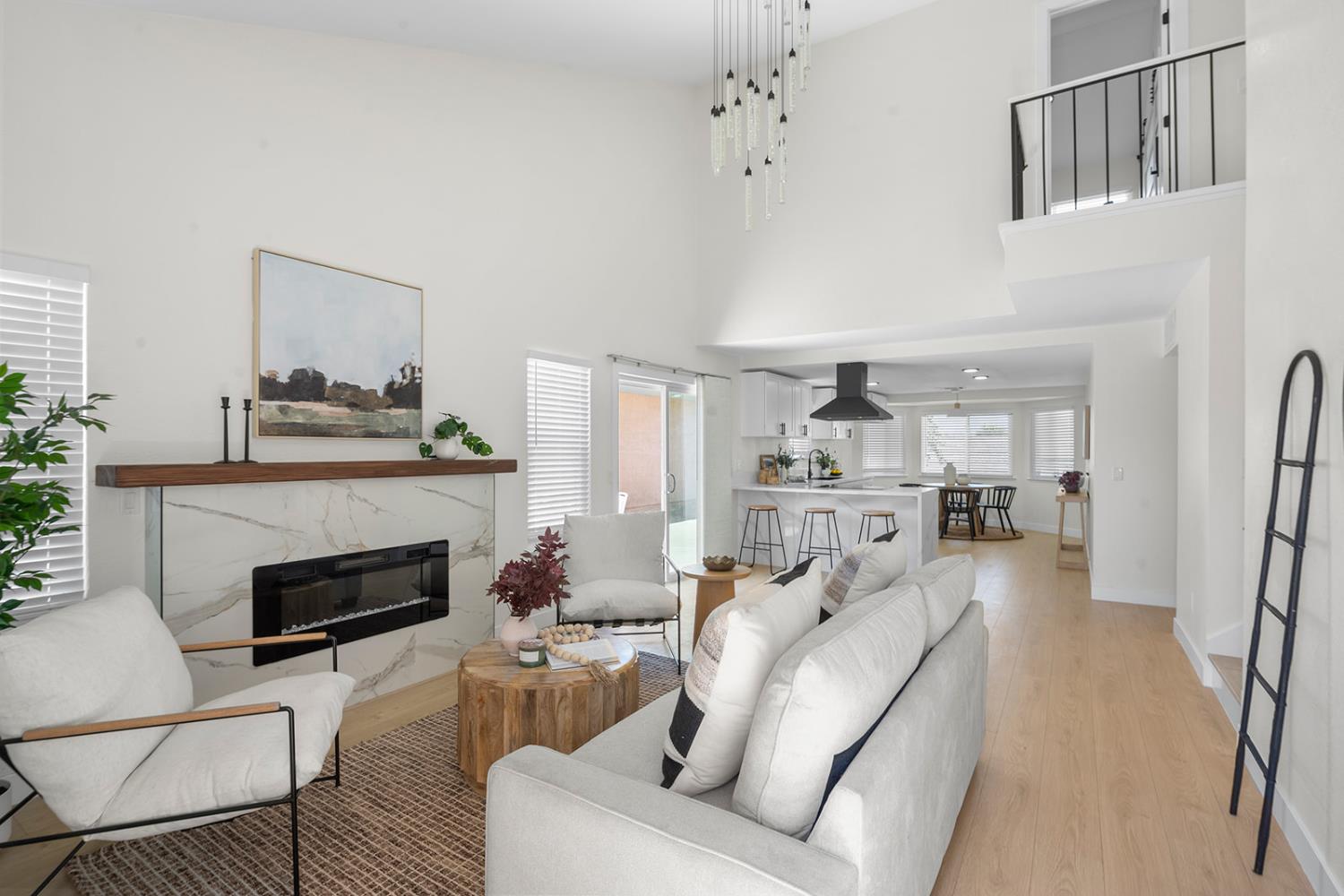 7531 Event Way Sacramento, CA 95842 - Photo 3 of 36 living room with a towering ceiling, a high end electric fireplace, and laminate floors