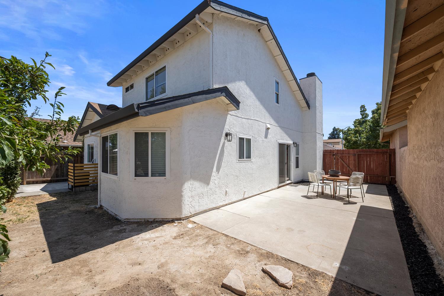 7531 Event Way Sacramento, CA 95842 - Photo 33 of 36 rear view of property with stucco siding, a patio, a fenced backyard, and a chimney