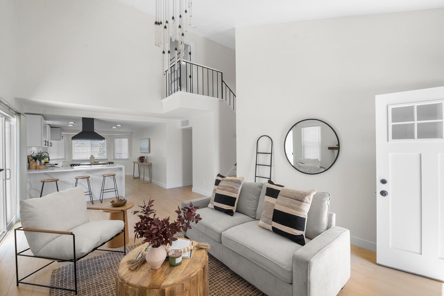 7531 Event Way Sacramento, CA 95842 - Photo 5 of 36 living area with a high ceiling, laminate flooring, and stairway