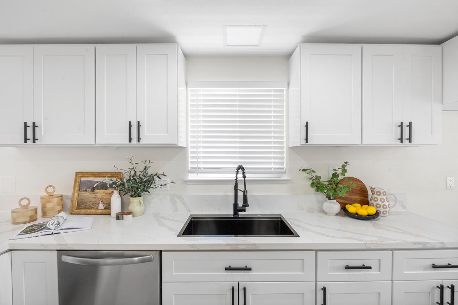 7531 Event Way Sacramento, CA 95842 - Photo 9 of 36 kitchen featuring stainless steel dishwasher, white cabinetry, and light quartz countertops