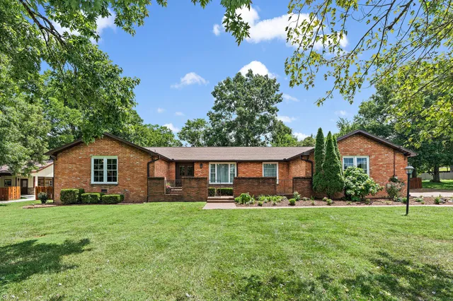 a front view of house with yard and green space