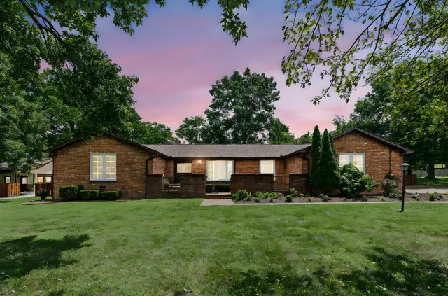 a front view of a house with a garden