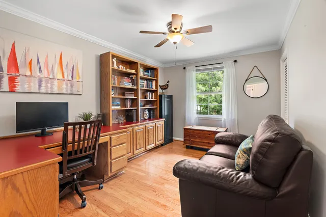 a view of a livingroom with furniture and a ceiling fan