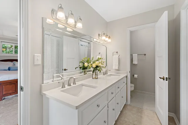 an aerial view of residential houses with outdoor space and trees