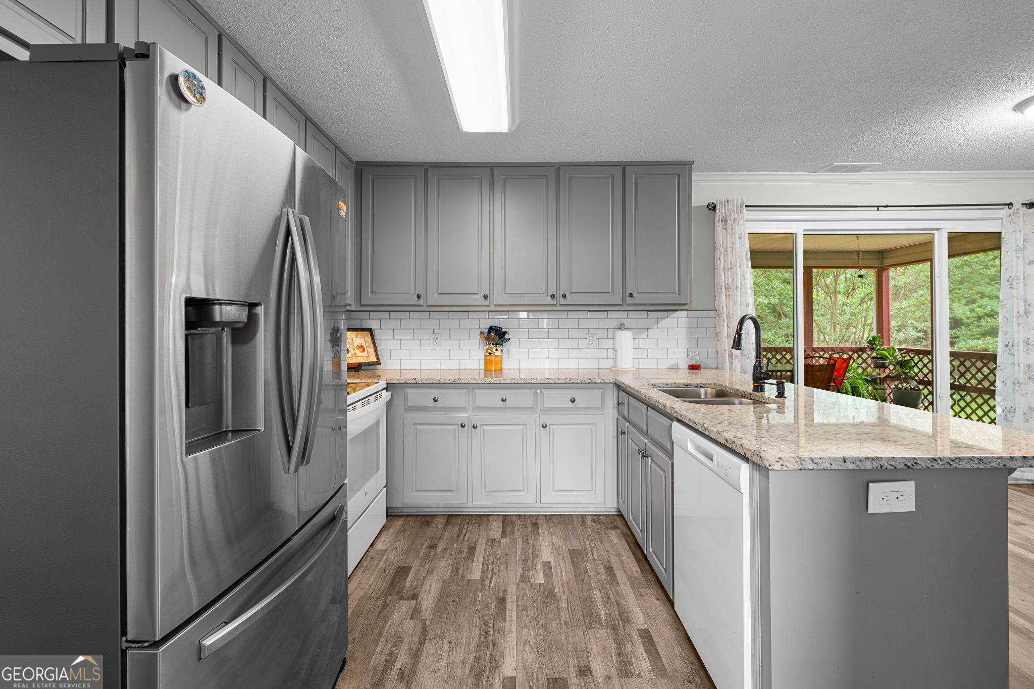 375 Gaelic Way Tyrone, GA 30290 - Photo 11 of 54 a kitchen with a refrigerator a sink and cabinets