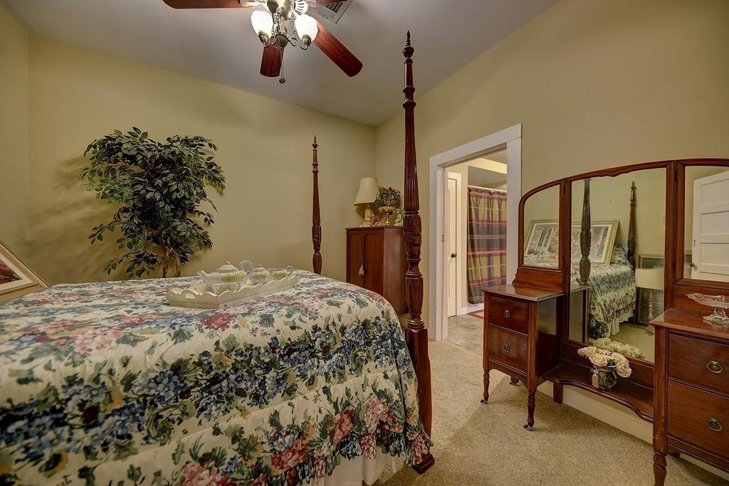 8456 Schuster Road Ledbetter, TX 78946 - Photo 32 of 49 a bedroom with a bed and a chandelier