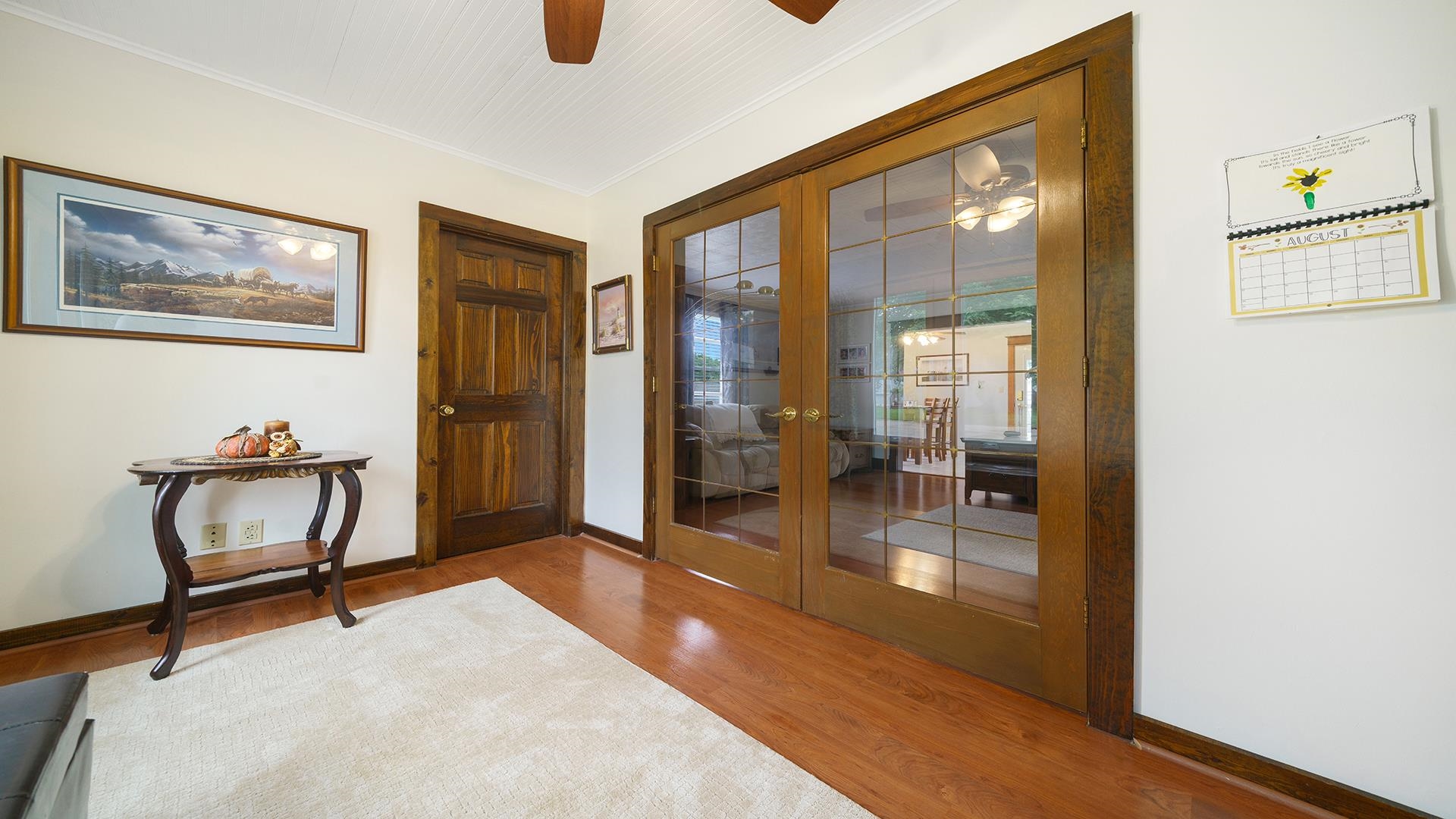 915 North 8th Street Rochelle, IL 61068 - Photo 14 of 38 a hallway with a dining table and couches with wooden floor