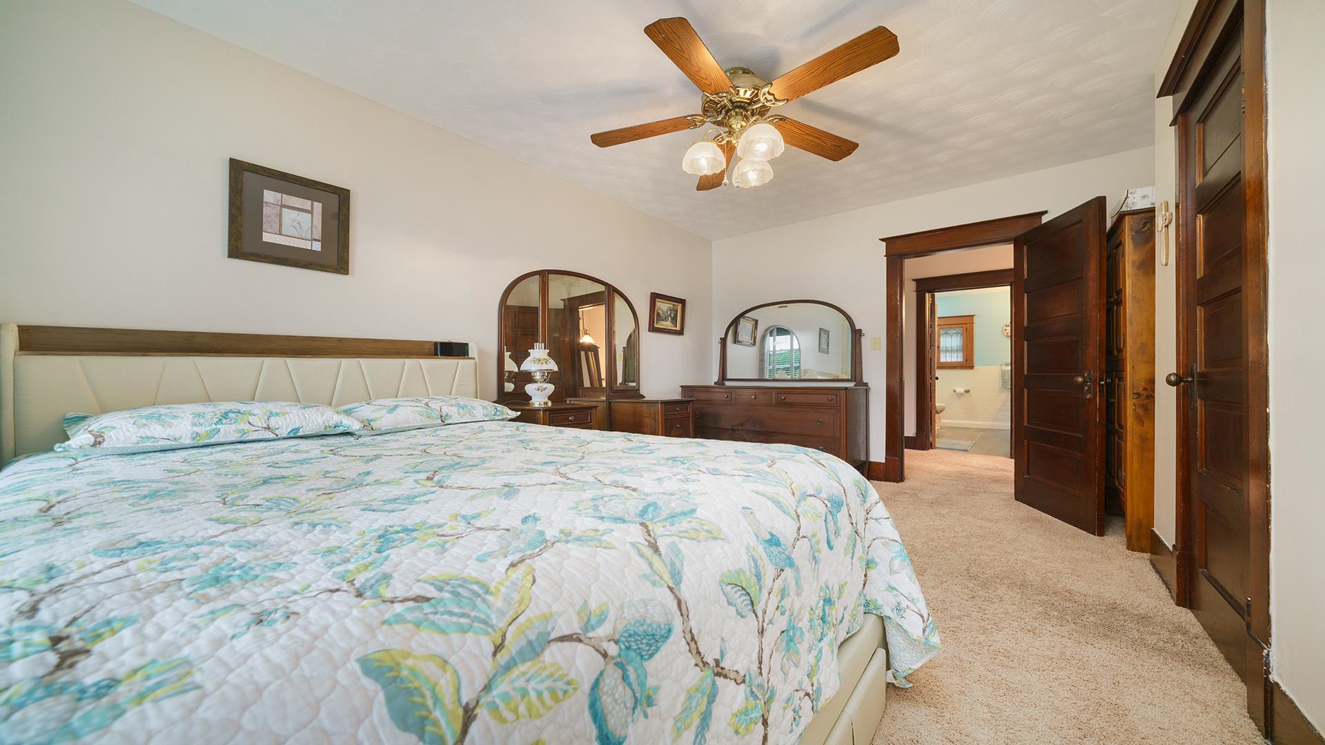 915 North 8th Street Rochelle, IL 61068 - Photo 17 of 38 a bedroom with a large bed and a chandelier