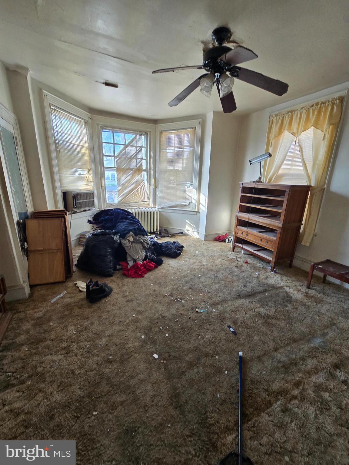 4611 Old York Road Philadelphia, PA 19140 - Photo 5 of 7 a bedroom with a bed and a chandelier