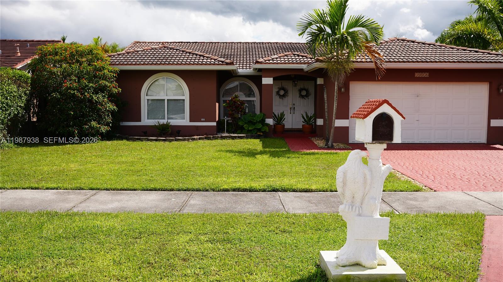 14856 Southwest 174th Street Miami, FL 33187 - Photo 11 of 28 a front view of a house with a yard