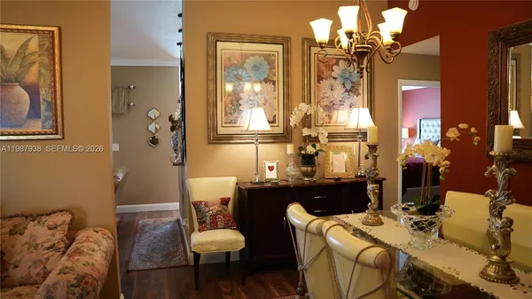 a living room with furniture a flat screen tv and kitchen view