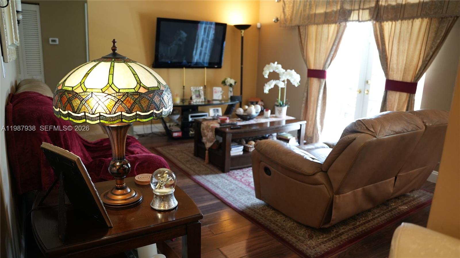14856 Southwest 174th Street Miami, FL 33187 - Photo 18 of 28 a living room with furniture and a mirror