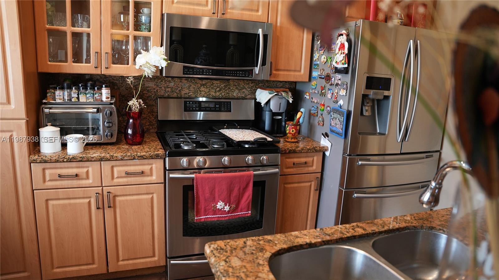 14856 Southwest 174th Street Miami, FL 33187 - Photo 20 of 28 a kitchen with stainless steel appliances granite countertop a stove and a refrigerator