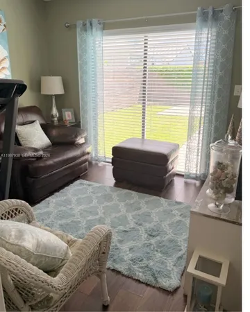 a bathroom with a sink a toilet a mirror and shower curtain