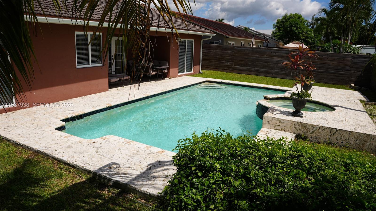 14856 Southwest 174th Street Miami, FL 33187 - Photo 4 of 28 a view of a backyard with pool