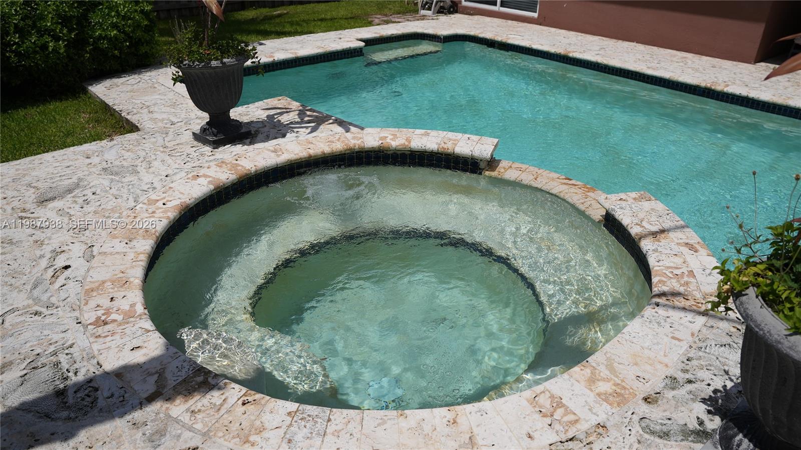 14856 Southwest 174th Street Miami, FL 33187 - Photo 7 of 28 an outdoor sitting area with an umbrella