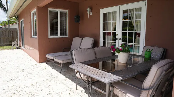 a bed sitting in a bedroom next to a lamp with workspace