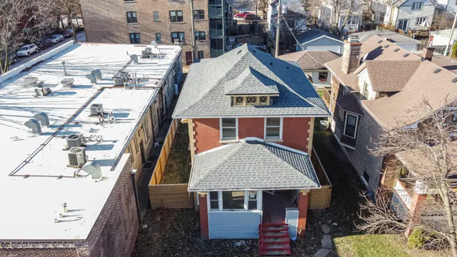 a aerial view of a house with a yard