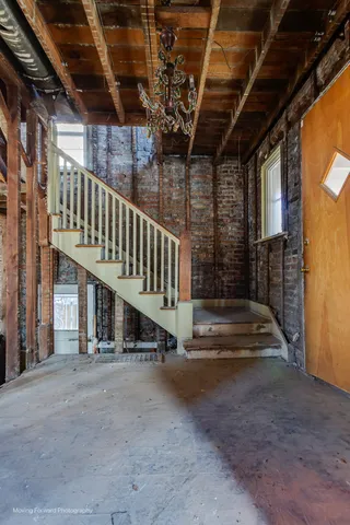 a view of staircase with a white door