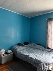 491-493 Newbury Street Springfield, MA 01104 - Photo 11 of 16 a bedroom with a bed and a window