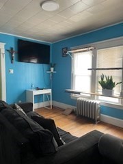 491-493 Newbury Street Springfield, MA 01104 - Photo 4 of 16 a bedroom with a bed and a window