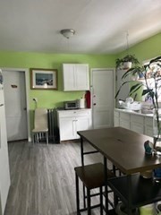 491-493 Newbury Street Springfield, MA 01104 - Photo 6 of 16 a kitchen with a table chairs sink and cabinets
