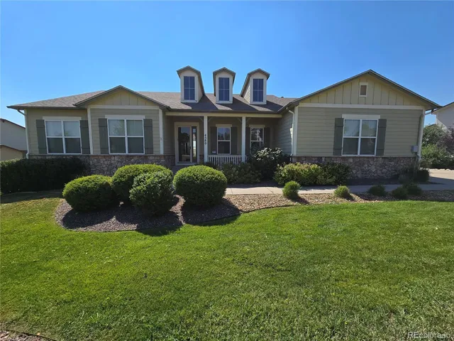 a front view of a house with a yard and porch