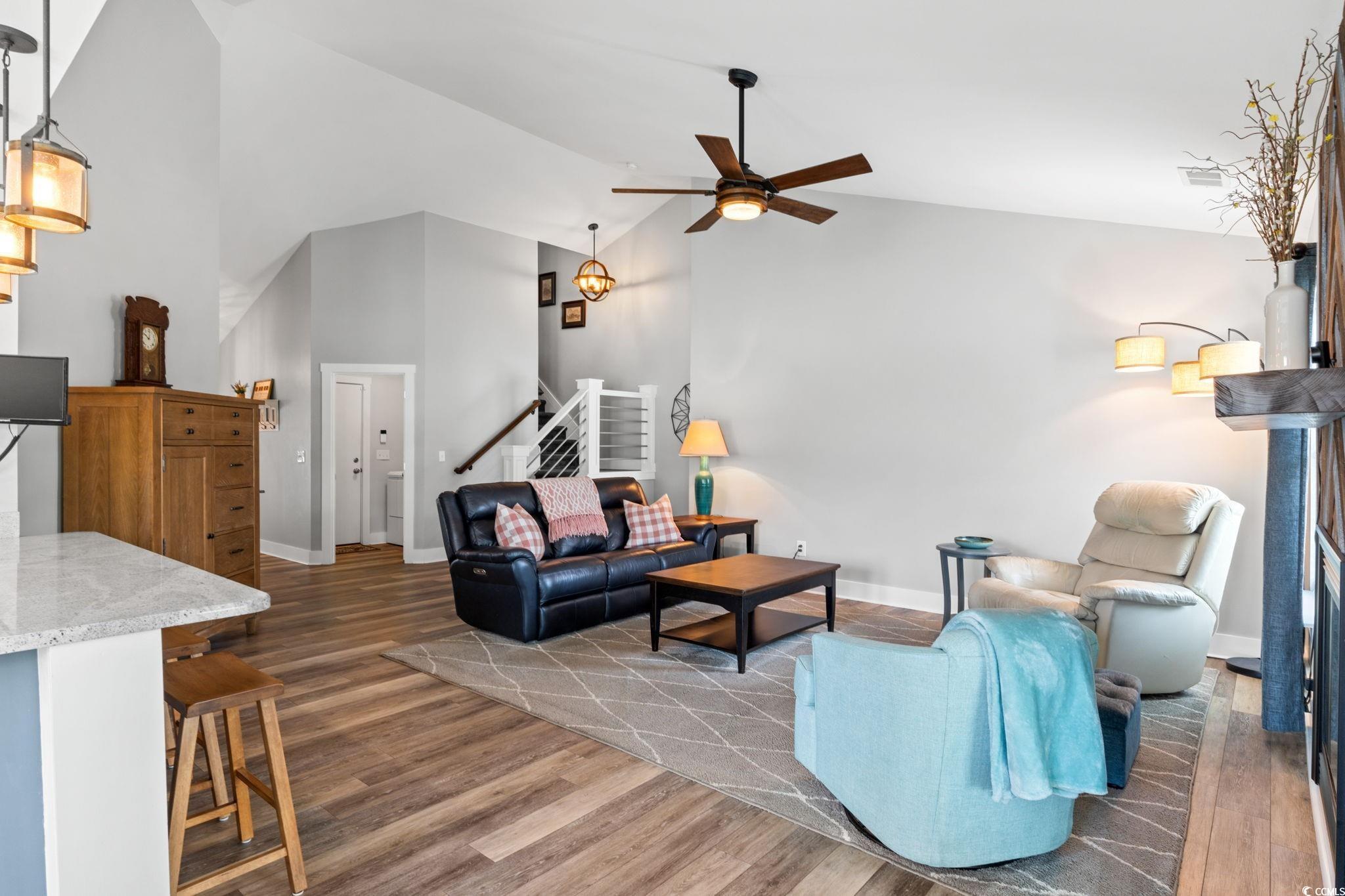 620 Seth Lane Longs, SC 29568 - Photo 11 of 35 Living area featuring wood finished floors, ceiling fan, stairway, baseboards, and high vaulted ceiling