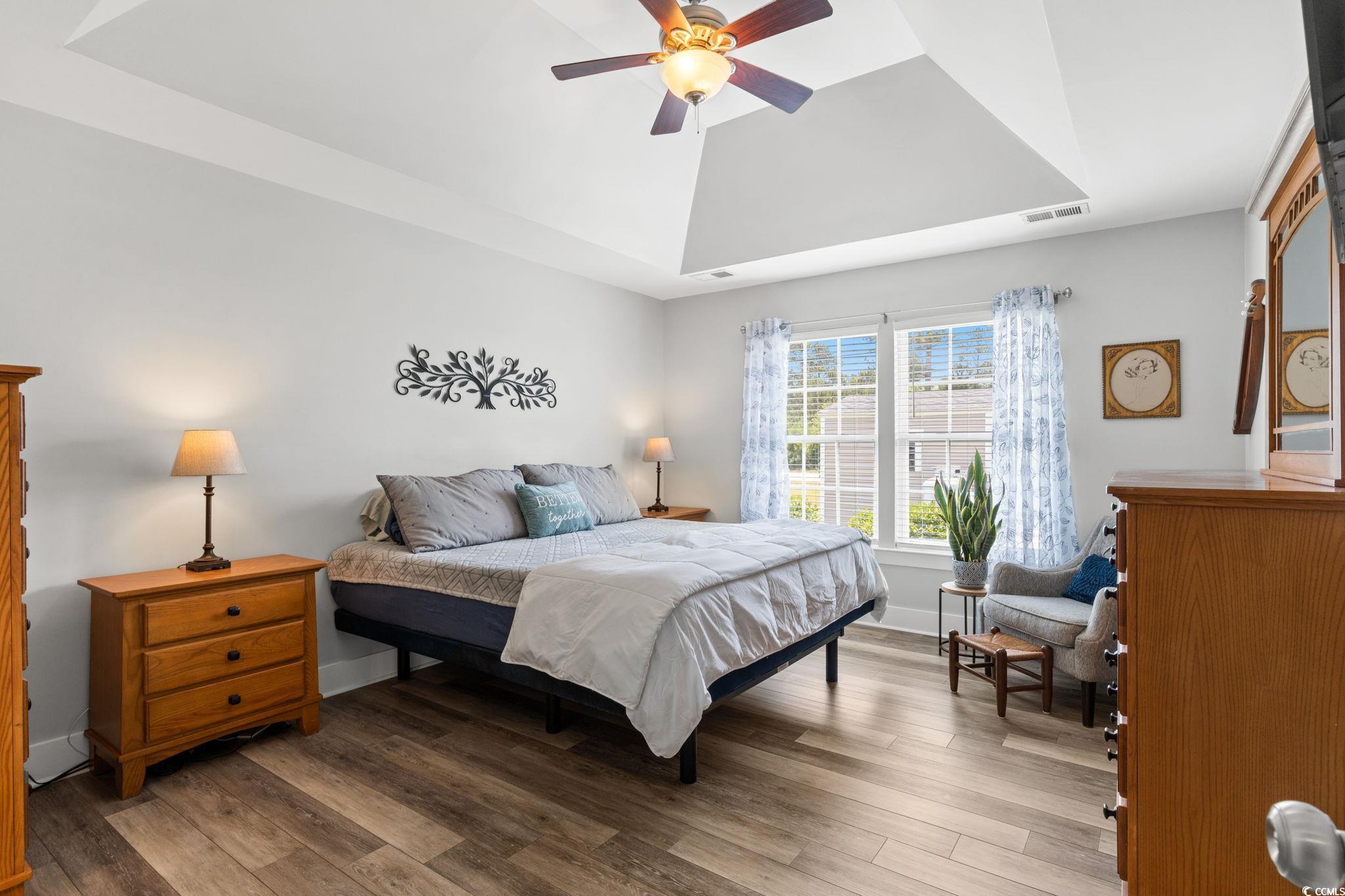 620 Seth Lane Longs, SC 29568 - Photo 12 of 35 Bedroom featuring wood finished floors, a tray ceiling, baseboards, and ceiling fan