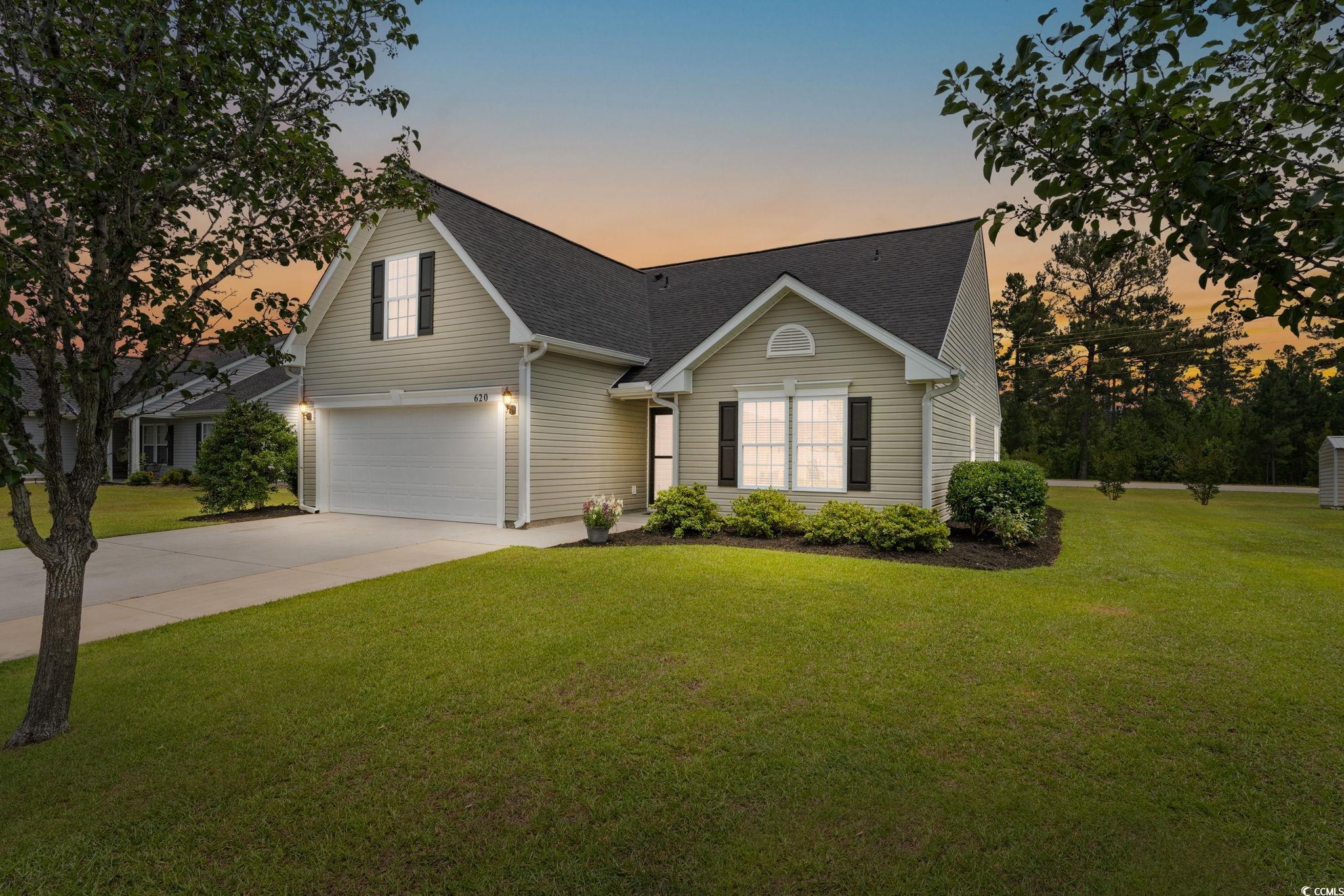 620 Seth Lane Longs, SC 29568 - Photo 2 of 35 Traditional-style house with an attached garage, driveway, a lawn, and roof with shingles