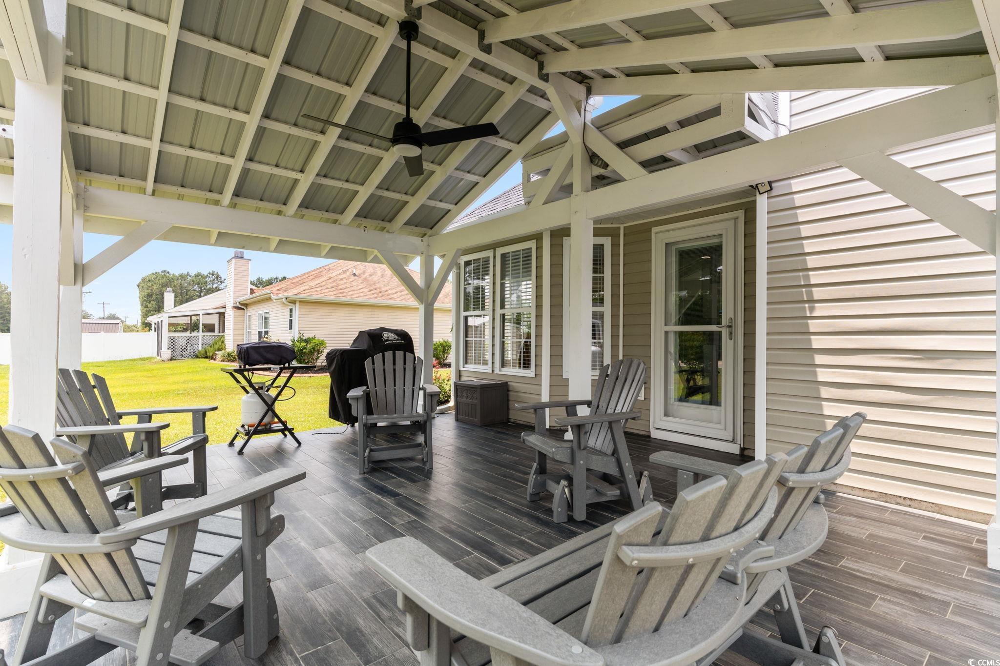 620 Seth Lane Longs, SC 29568 - Photo 25 of 35 Wooden deck with a ceiling fan and a lawn