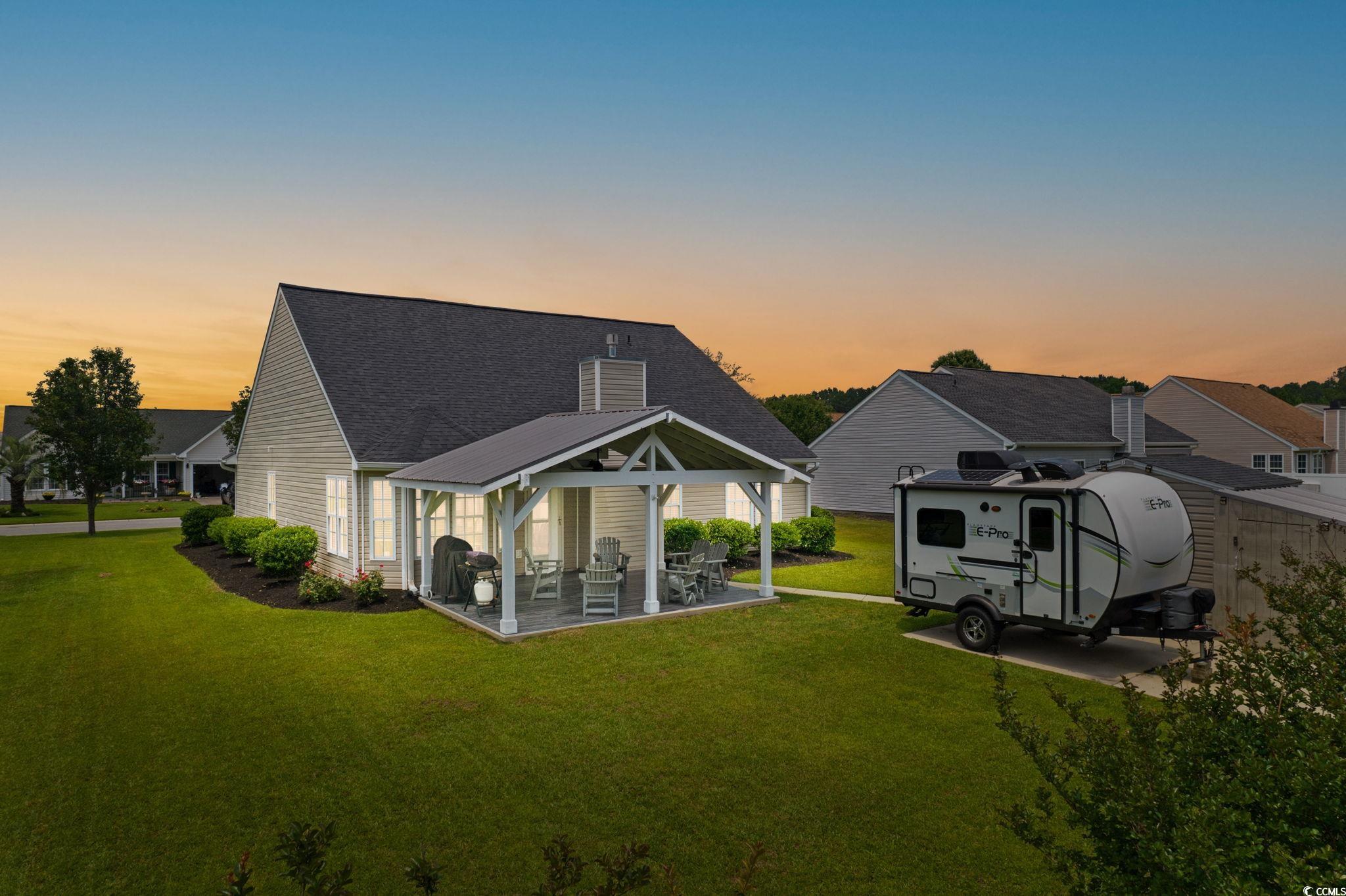 620 Seth Lane Longs, SC 29568 - Photo 3 of 35 Rear view of property with a gazebo, a lawn, a shingled roof, a patio area, and a chimney