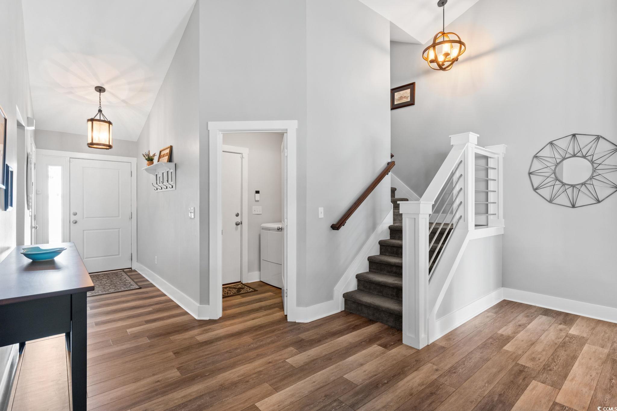 620 Seth Lane Longs, SC 29568 - Photo 6 of 35 Entryway with wood finished floors, baseboards, stairs, and high vaulted ceiling