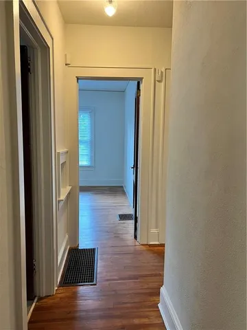 a view of a hallway with wooden floor