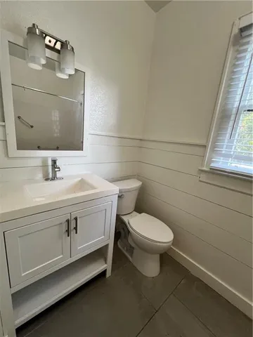 a bathroom with a sink vanity and toilet