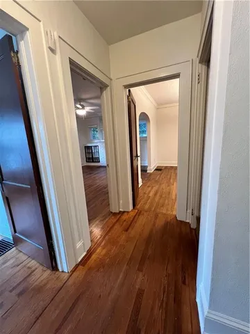 a view of hallway with wooden floor