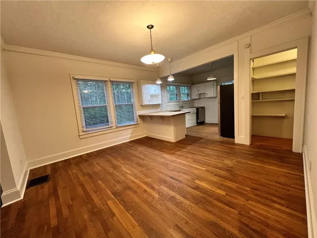 a view of a room with wooden floor and window