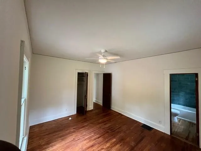 an empty room with wooden floor and closet