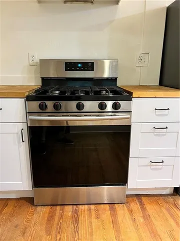 a stove top oven sitting inside of a kitchen